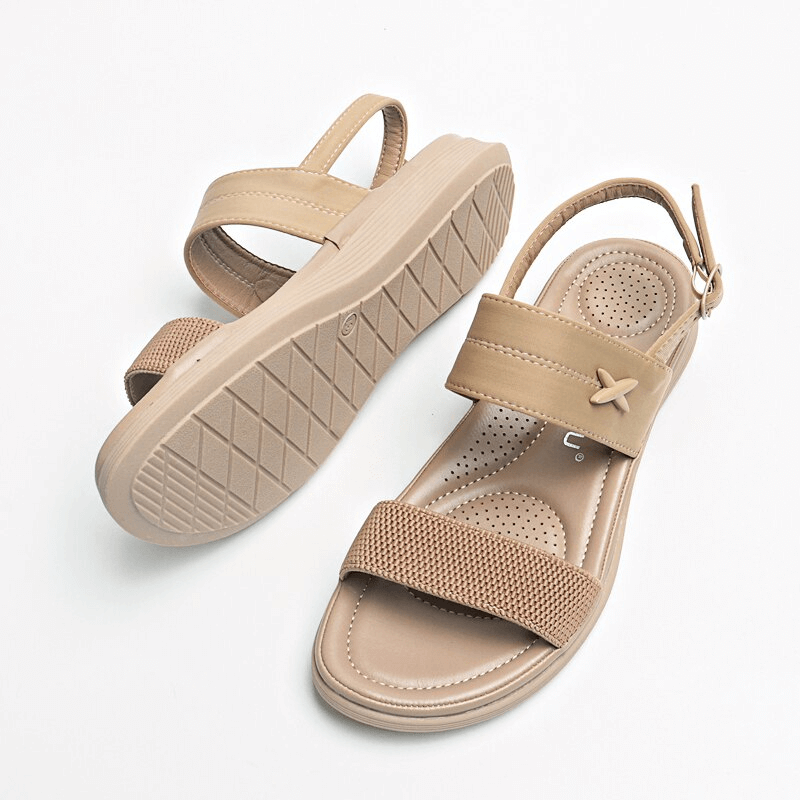 Women's outdoor flat beach sandals in tan with buckle strap closure, PU leather upper, and TPR outsole. Comfortable and stylish design.